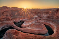 Classic view of an intense sunburst overlooking Reflection Canyon
