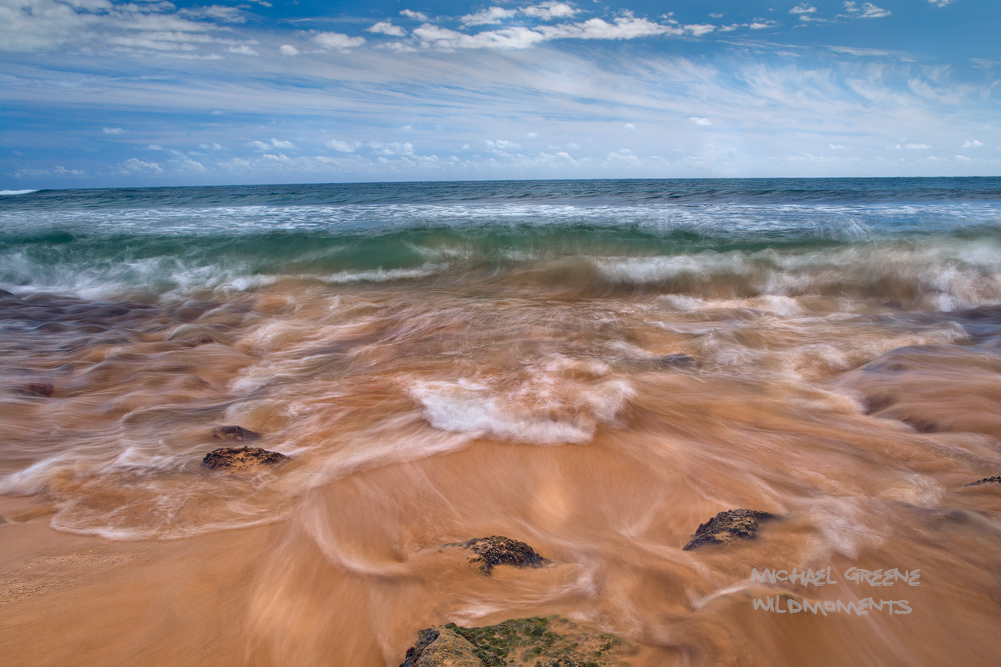 Incoming and outgoing tidal patterns of the Pacific Ocean intersect at a remote section of shoreline near Poipu Beach, Hawaii...