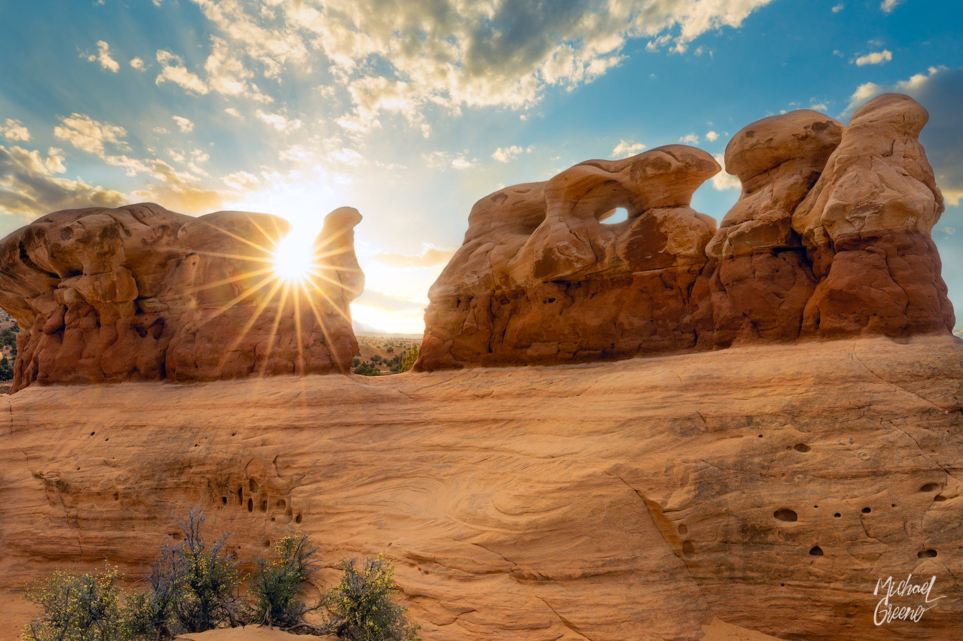A dramatic sunburst through an iconic rock formation at the Devil's Garden in the Grand Staircase Escalate National Monument...