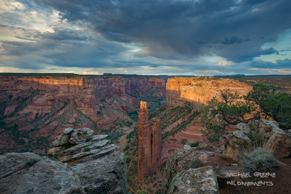 Sublime sunset light in Canyon De Chelly National Monument amid dark blue monsoonal skies. 