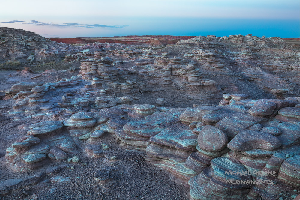 Blue hour vistas of the painted desert from a rocky perch in the Petrified Forest. This national park is located near Holbrook...