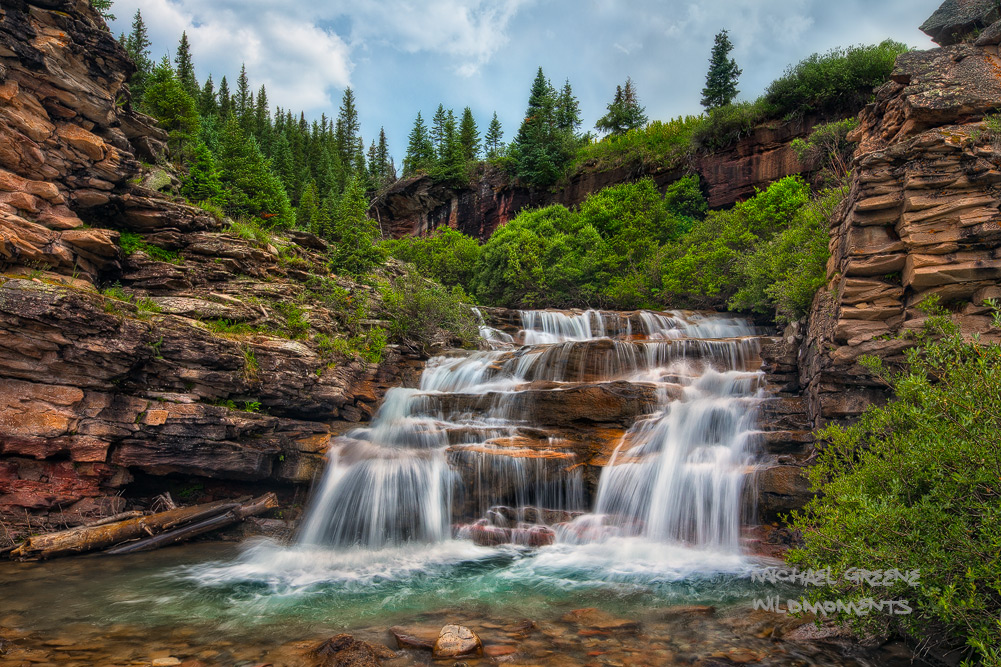 A stunning waterfall in a hidden gorge near Ouray, Colorado captured on a stormy, summer evening.