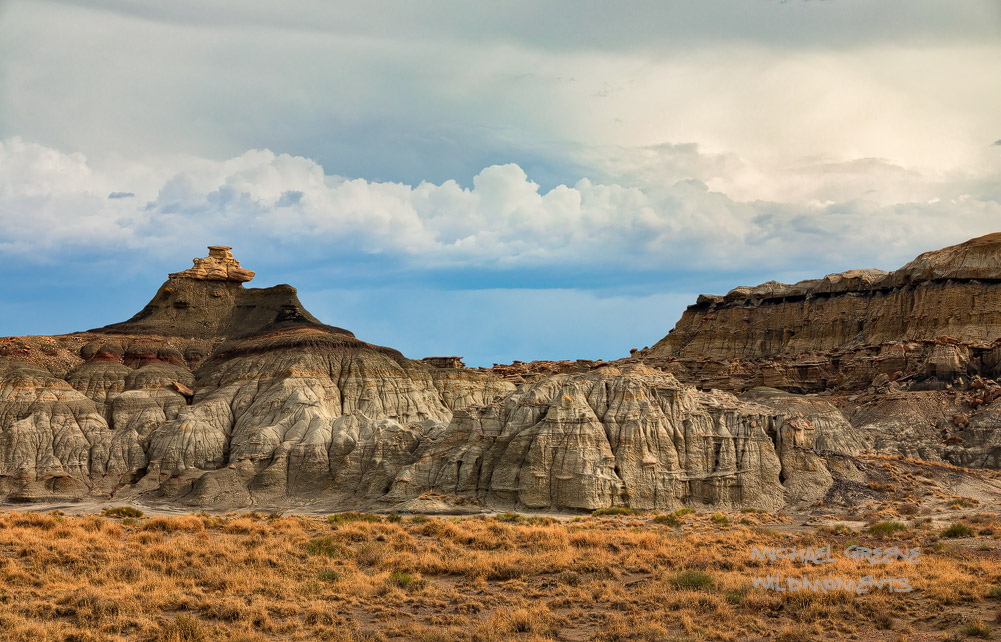 Incredibly low monsoon clouds help showcase the arid high desert badlands with late afternoon storm light in northern New Mexico...