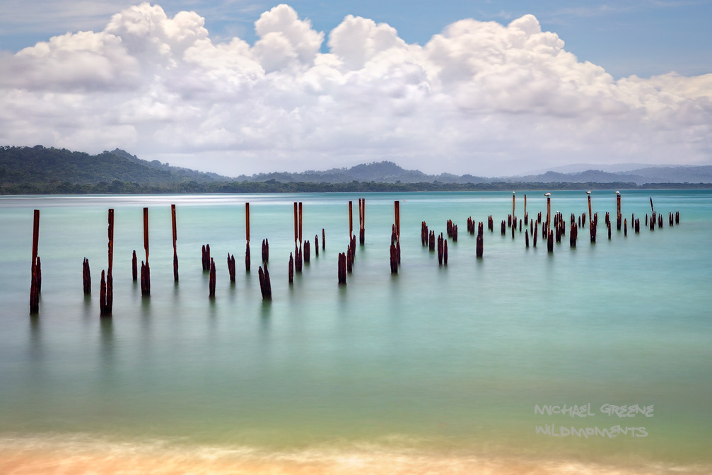 A time lapse photo of an old pier in the central portion of the beach hike at Cahuita National Park. This park is located in...