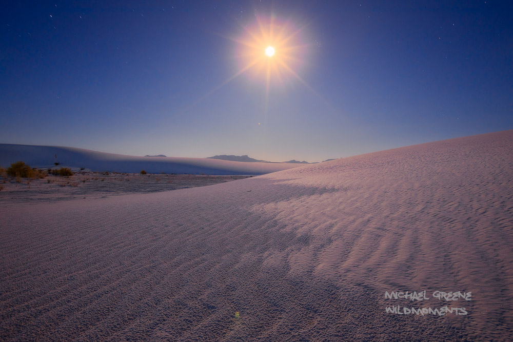 Full moon light shines through the backcountry dunes in White Sands National Park captured on a frigid late autumn evening. White...