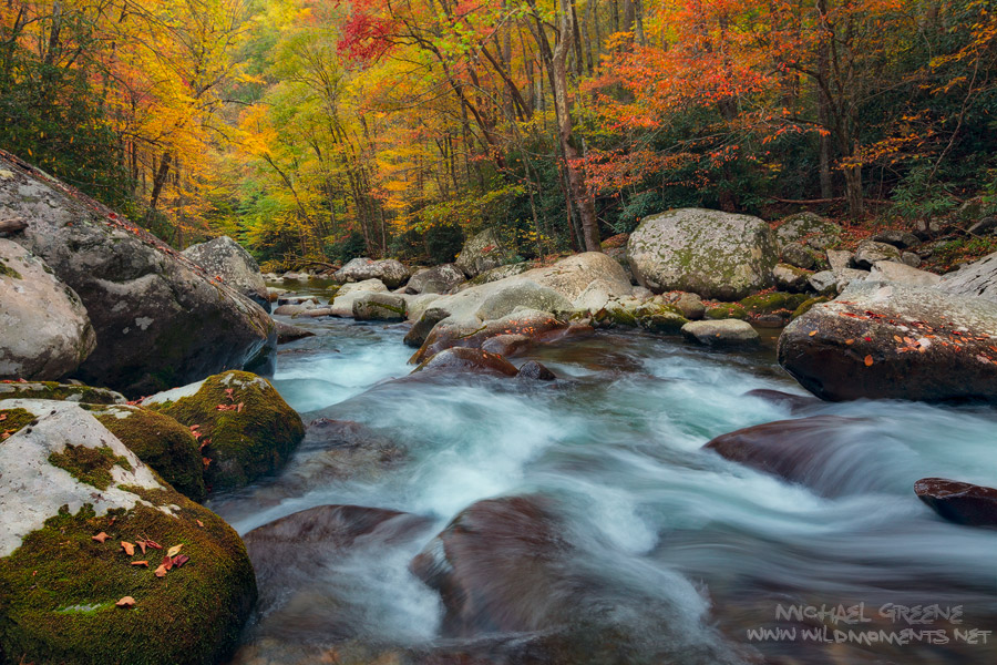 The massive boulders of Big Creek are decorated with autumn leaves amidst a backdrop of fall colors.