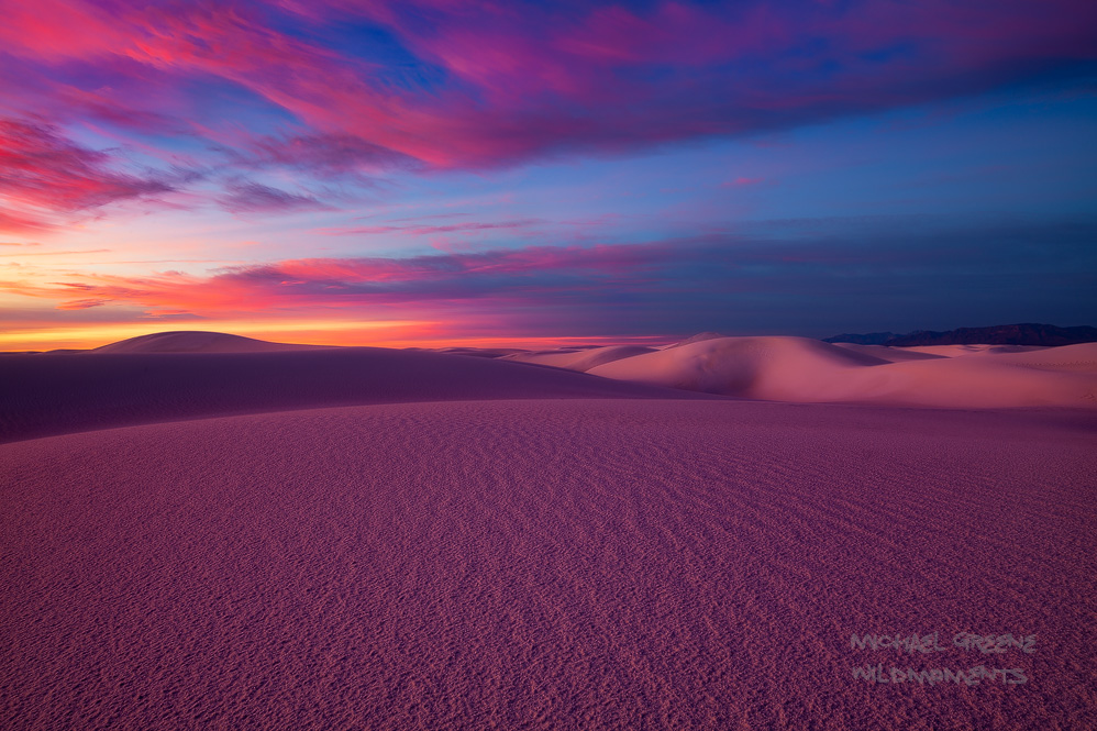 This image features peak colors of a fantastic sunrise during a full moon set in the backcountry of White Sands National Monument...