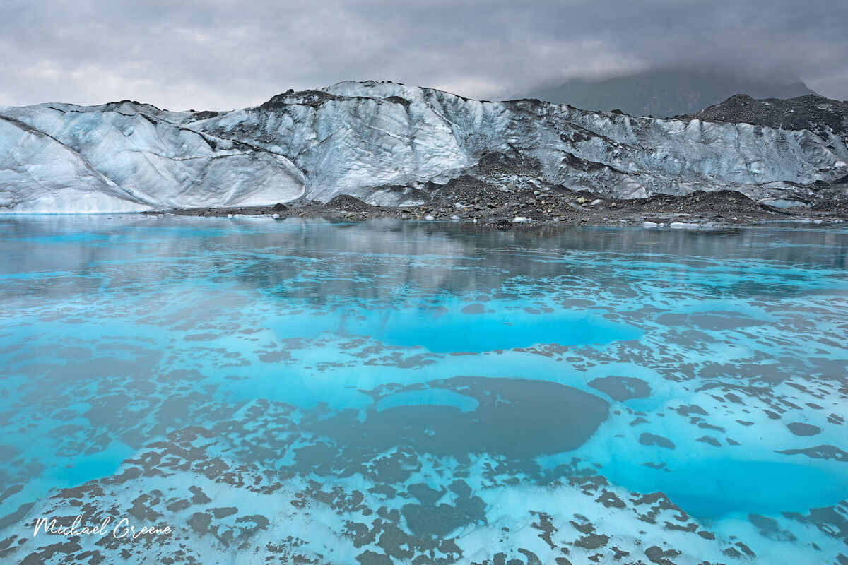 You are looking at a small glacial melt pool late captured on a rainy afternoon late in the summer season deep within a secluded...