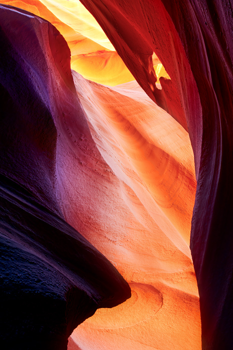 Intense arrays of colors decorate the sandstone walls of Antelope Canyon. Here the small hole in the rock adds texture and character...