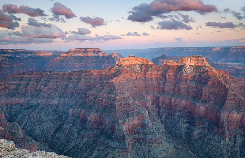 Fast moving clouds are briefly illuminated during the time of last light near Point Sublime at the North Rim, Arizona.