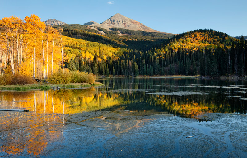 A profusion of fall colors accented by stillness, blue skies, and warm light on a&nbsp;quiet evening at Woods Lake near Telluride...