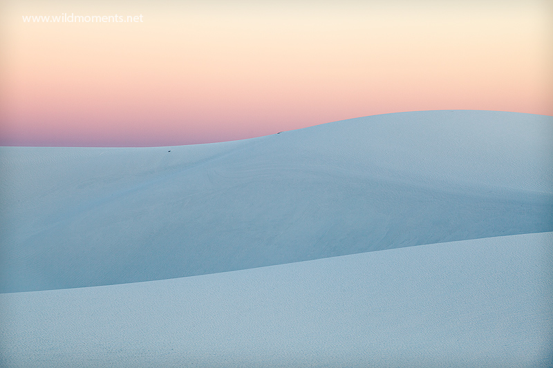 The mirroring and meandering flow of white sands captured at sunset.