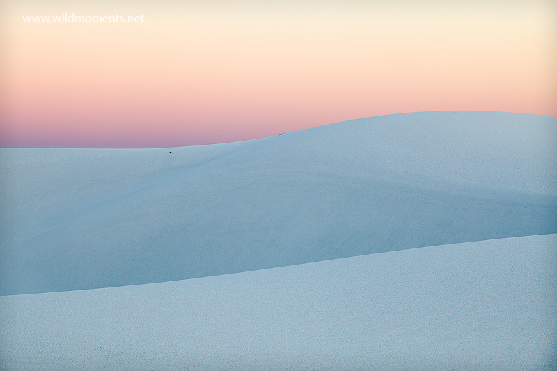 The mirroring and meandering flow of white sands captured at sunset.