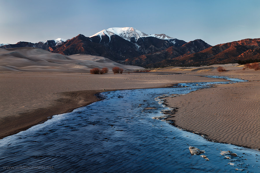 The nascent stages of Medano Creek (framed by the Sangre De Cristo Mountains) captured here in early spring at sunset on crisp...