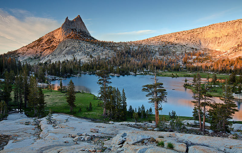 The golden glow&nbsp;of sunset&nbsp;dapples briefly on the high crests of Cathedral Peak (10,991 ft)&nbsp;and in the waters of...